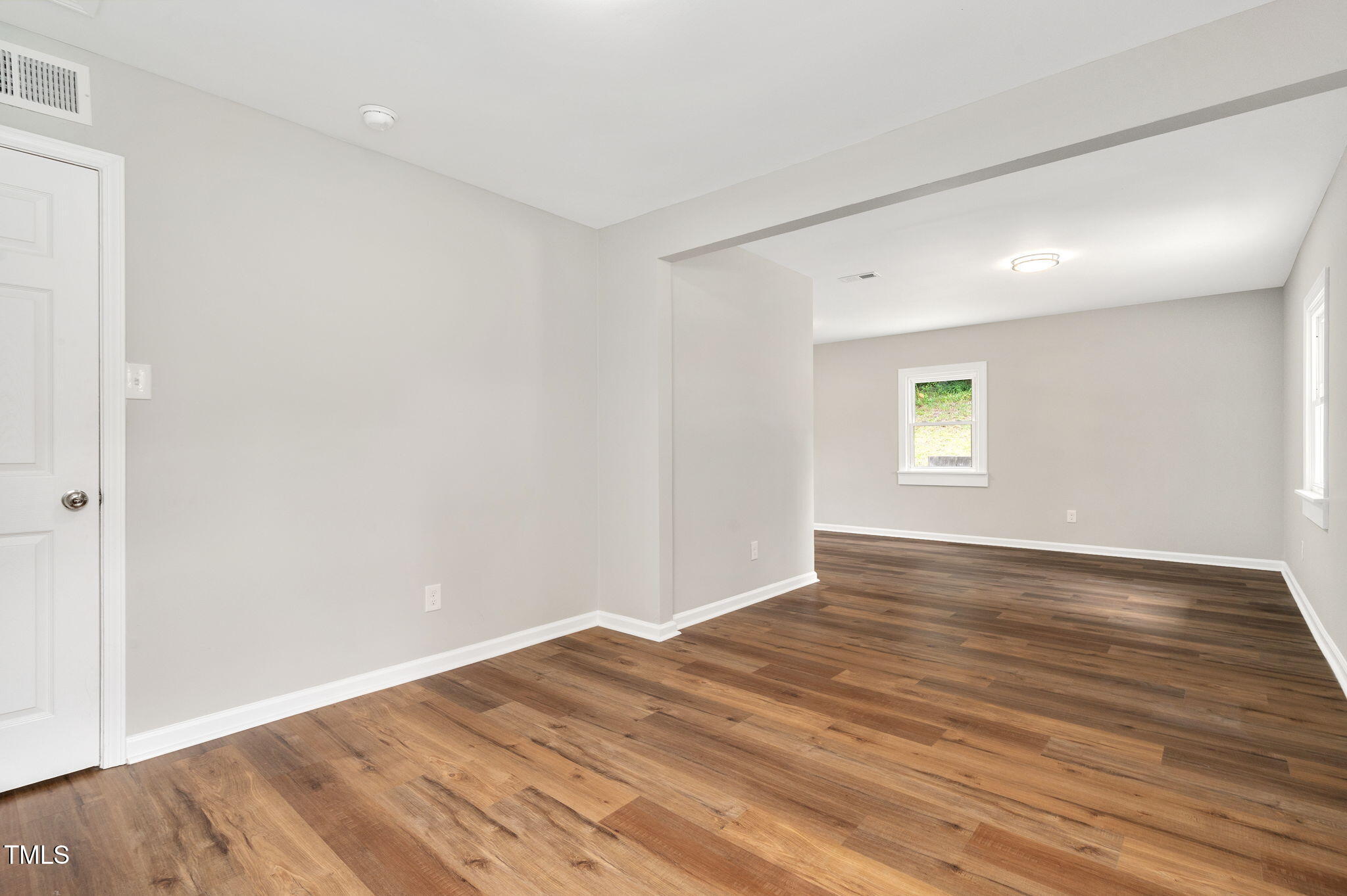 529 Solar Drive Raleigh, NC 27610 - Photo 14 of 18 an empty room with wooden floor and windows