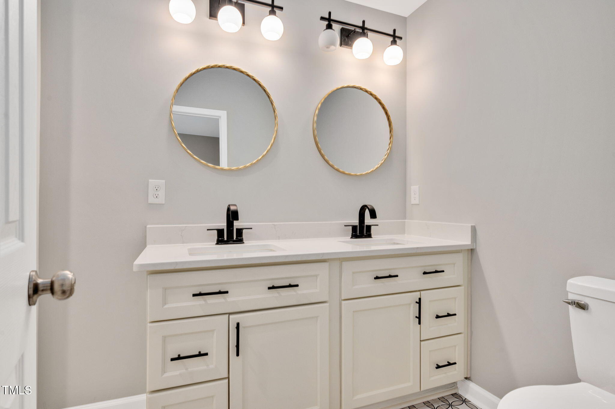 529 Solar Drive Raleigh, NC 27610 - Photo 17 of 18 a bathroom with a double vanity sink and a mirror