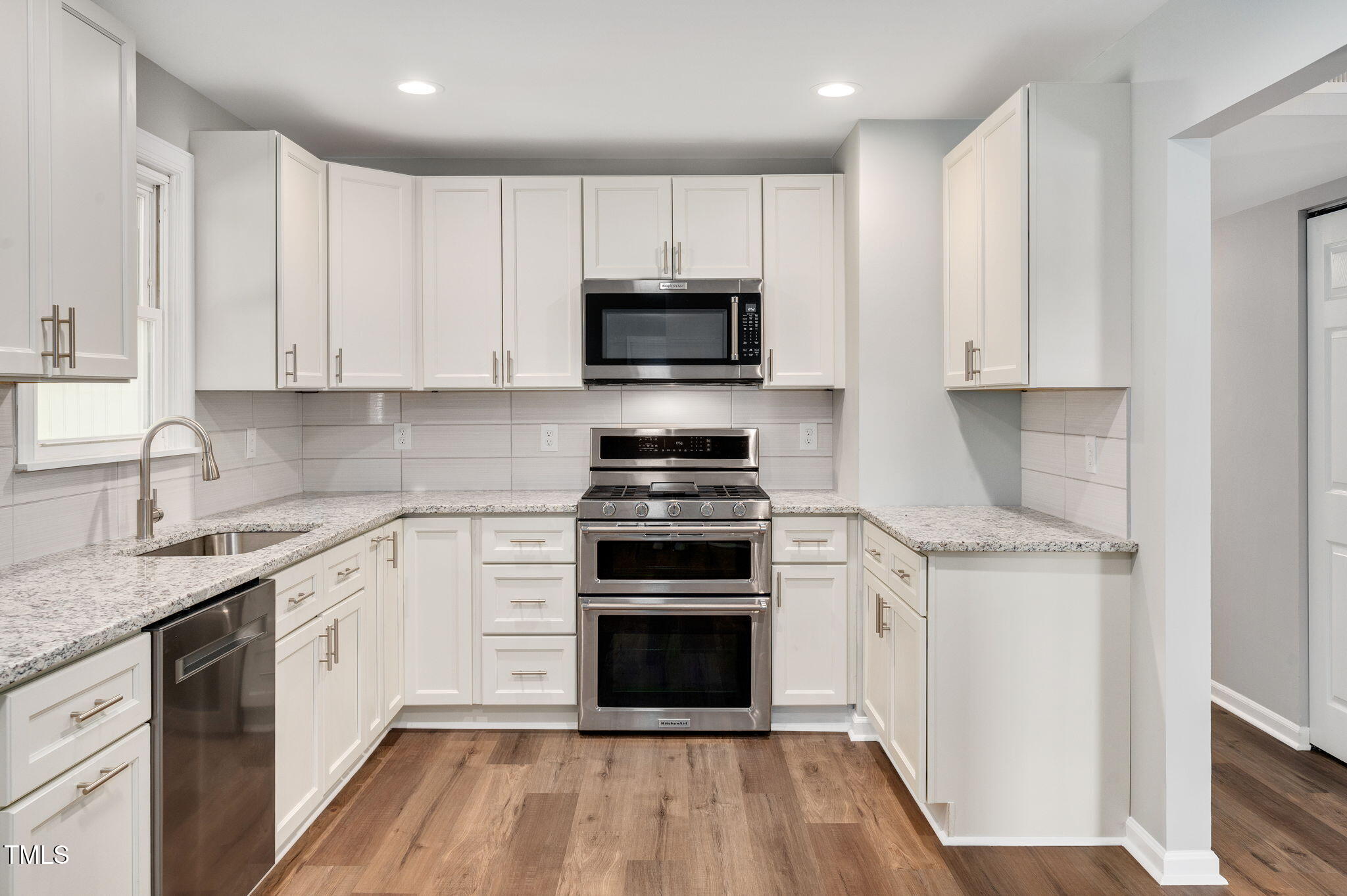529 Solar Drive Raleigh, NC 27610 - Photo 6 of 18 a kitchen with granite countertop white cabinets and stainless steel appliances