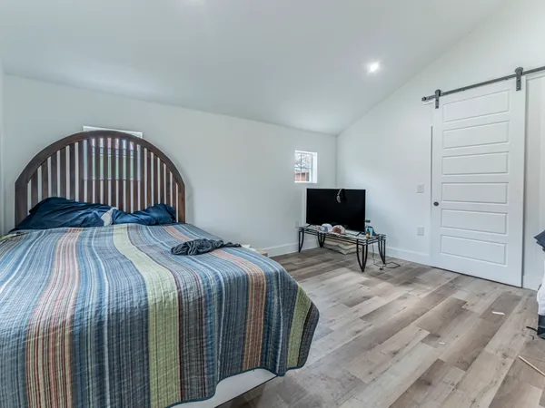 a bedroom with a bed and a flat screen tv