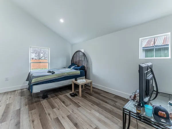 a living room with furniture a piano and wooden floor