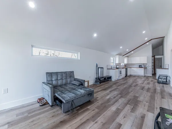 a living room with a couch and wooden floor