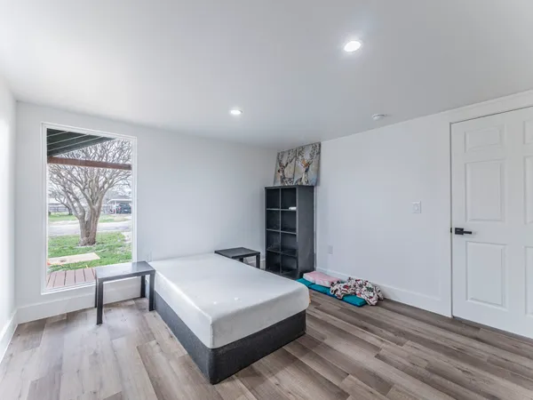 a bedroom with a bed and a window