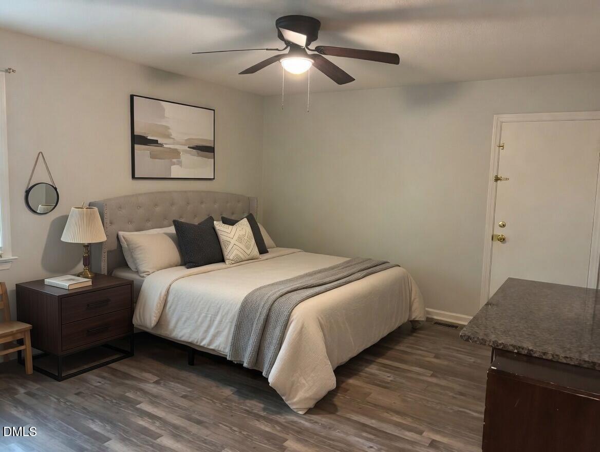 3102 Summit Road Goldsboro, NC 27534 - Photo 14 of 30 a bedroom with a bed and wooden floor