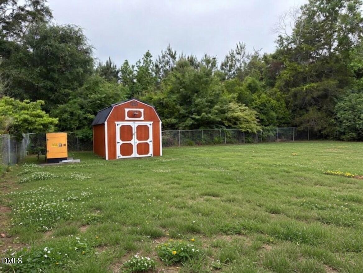 3102 Summit Road Goldsboro, NC 27534 - Photo 20 of 30 a view of a backyard with a garden and entertaining space