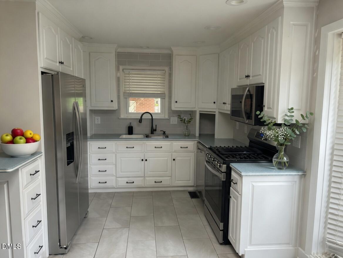 3102 Summit Road Goldsboro, NC 27534 - Photo 8 of 30 a kitchen with white cabinets and appliances