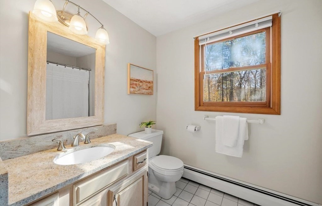 107 Ash Street Rehoboth, MA 02769 - Photo 12 of 34 a bathroom with a granite countertop sink mirror vanity and toilet