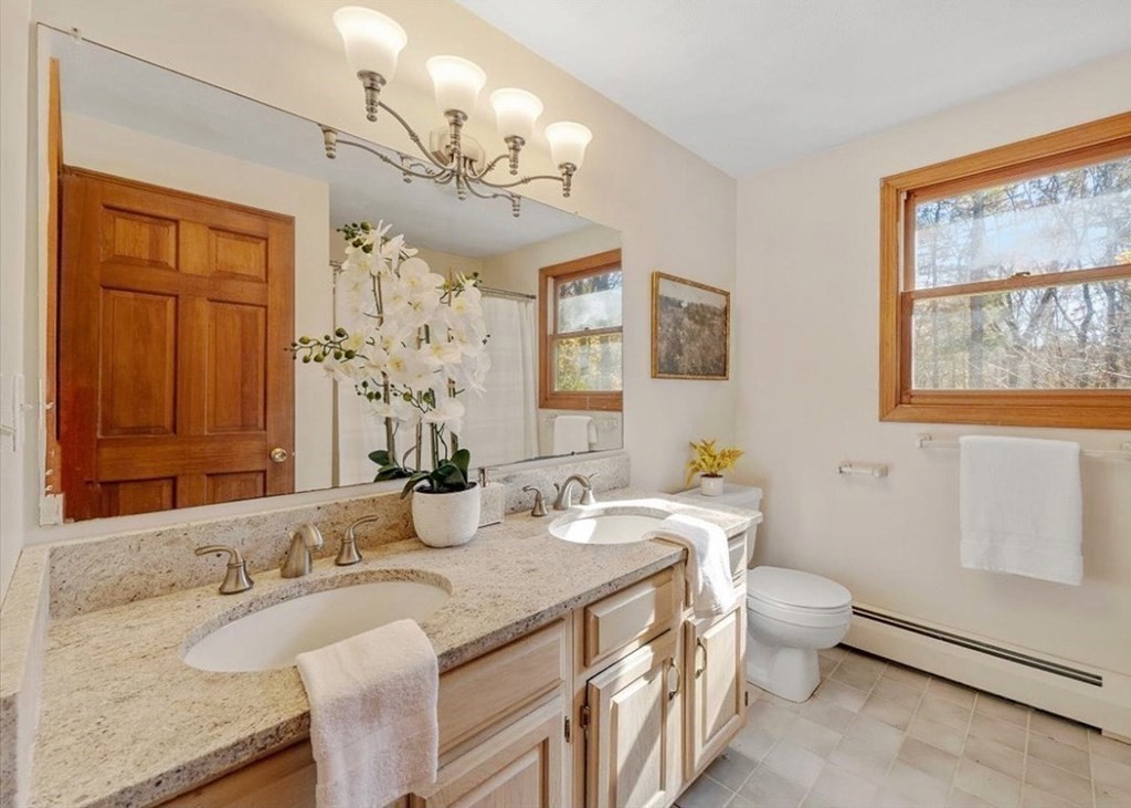 107 Ash Street Rehoboth, MA 02769 - Photo 22 of 34 a bathroom with a granite countertop double vanity sink a mirror and a bathtub