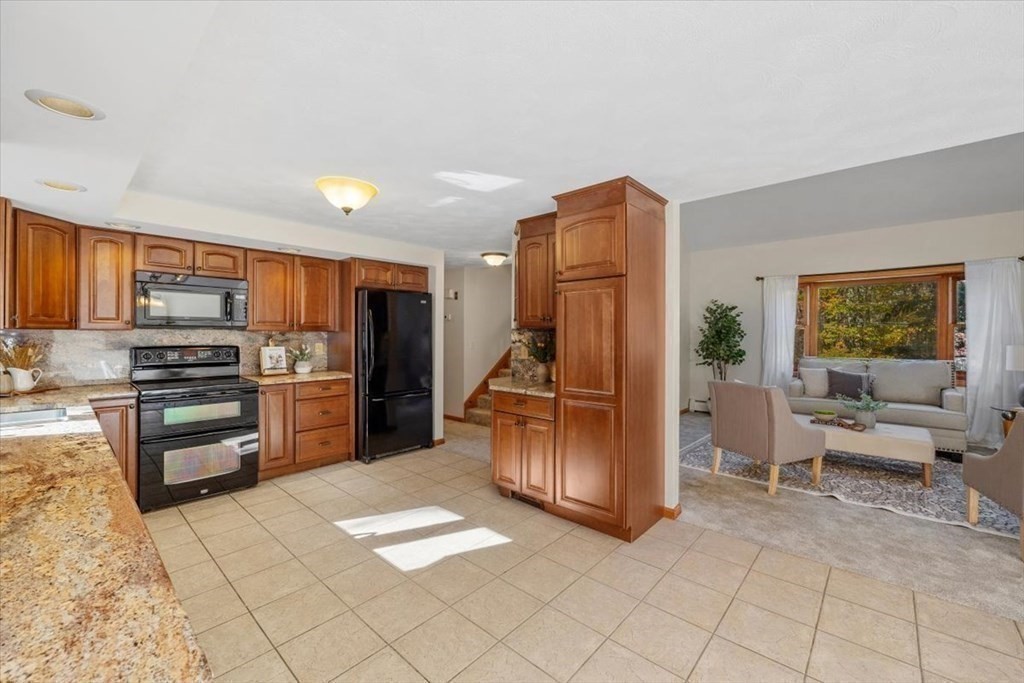 107 Ash Street Rehoboth, MA 02769 - Photo 8 of 34 a kitchen with stainless steel appliances a refrigerator and a stove top oven