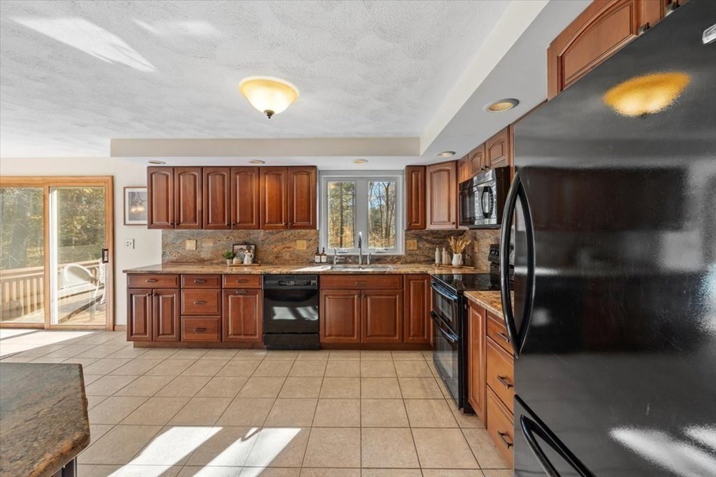 107 Ash Street Rehoboth, MA 02769 - Photo 10 of 34 a kitchen with a sink and a refrigerator