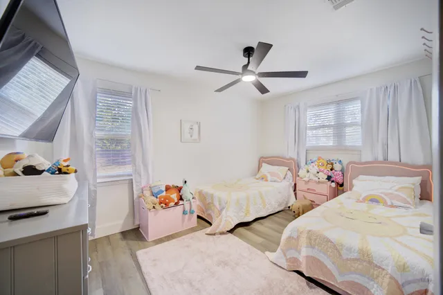 a bedroom with two beds and a window