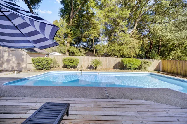 a view of a yard with wooden fence