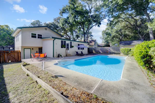 a view of a house with backyard and sitting area