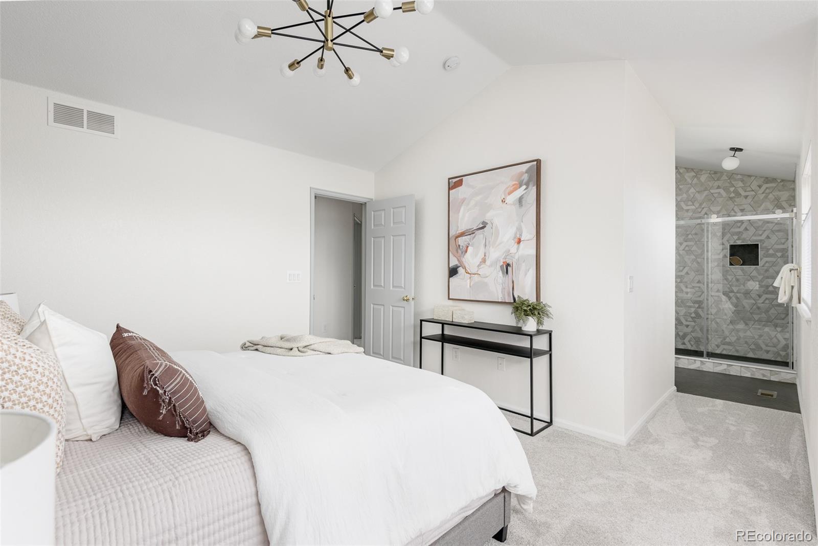 10754 West 107th Circle Westminster, CO 80021 - Photo 17 of 24 a bedroom with a bed and a table