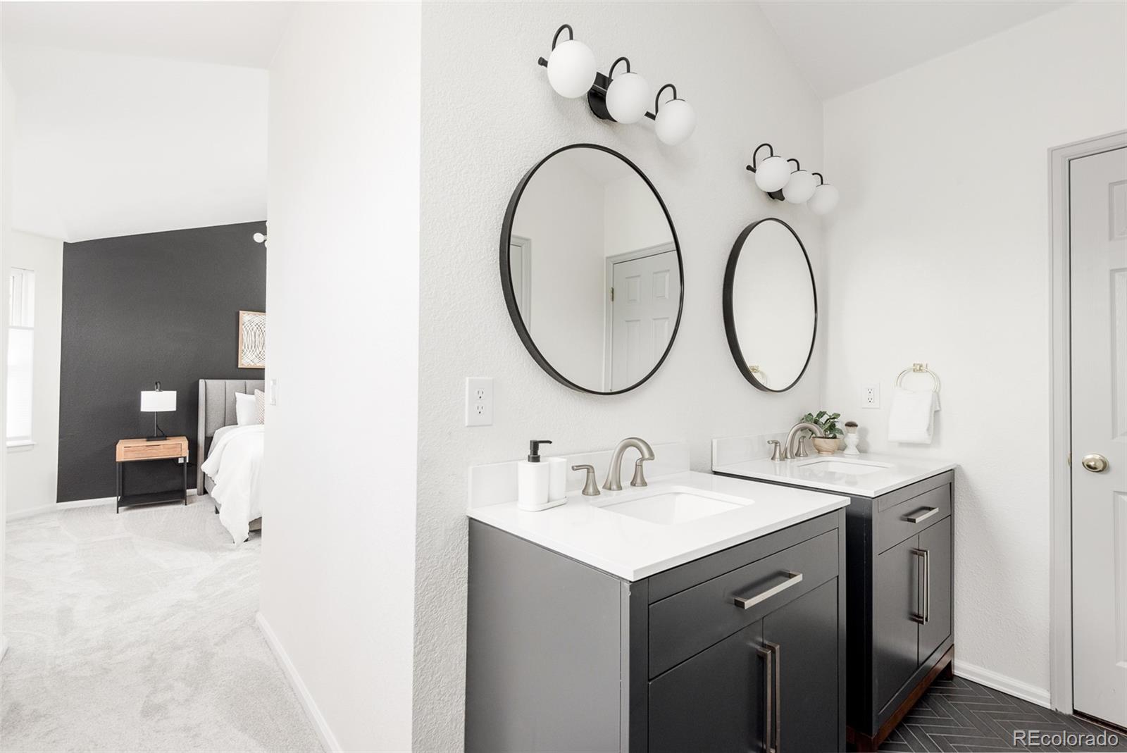10754 West 107th Circle Westminster, CO 80021 - Photo 19 of 24 a bathroom with a double vanity sink and a mirror