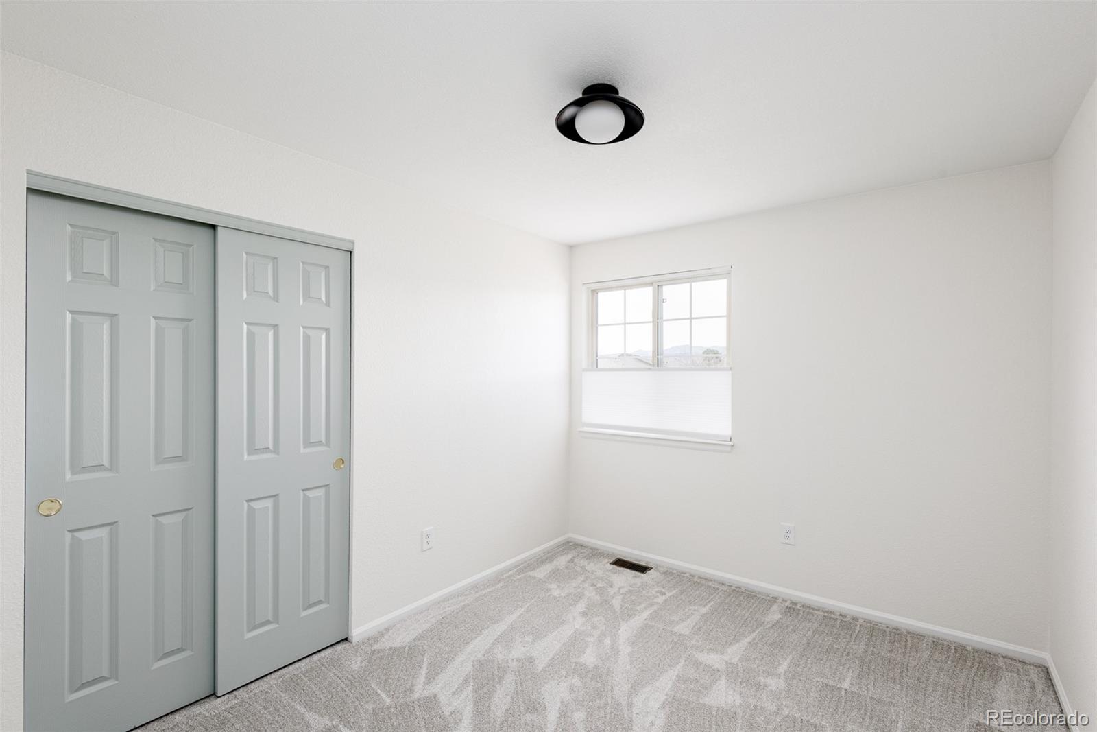 10754 West 107th Circle Westminster, CO 80021 - Photo 20 of 24 an empty room with windows