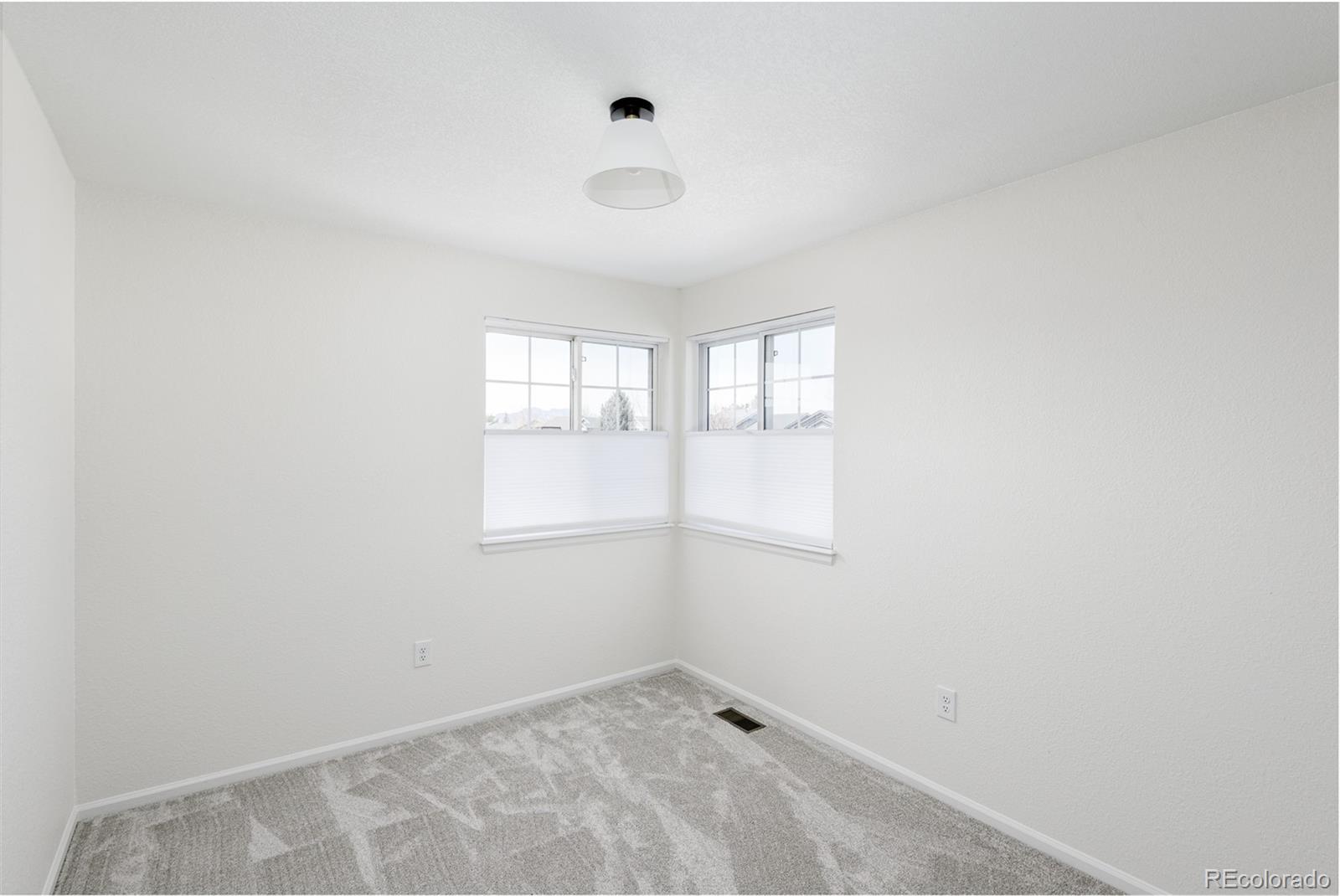 10754 West 107th Circle Westminster, CO 80021 - Photo 22 of 24 an empty room with windows