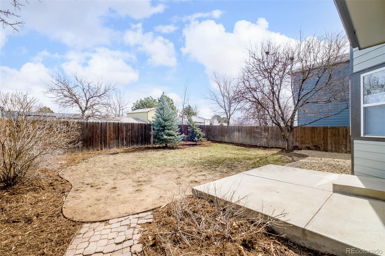 10754 West 107th Circle Westminster, CO 80021 - Photo 23 of 24 a view of a yard with snow on the road