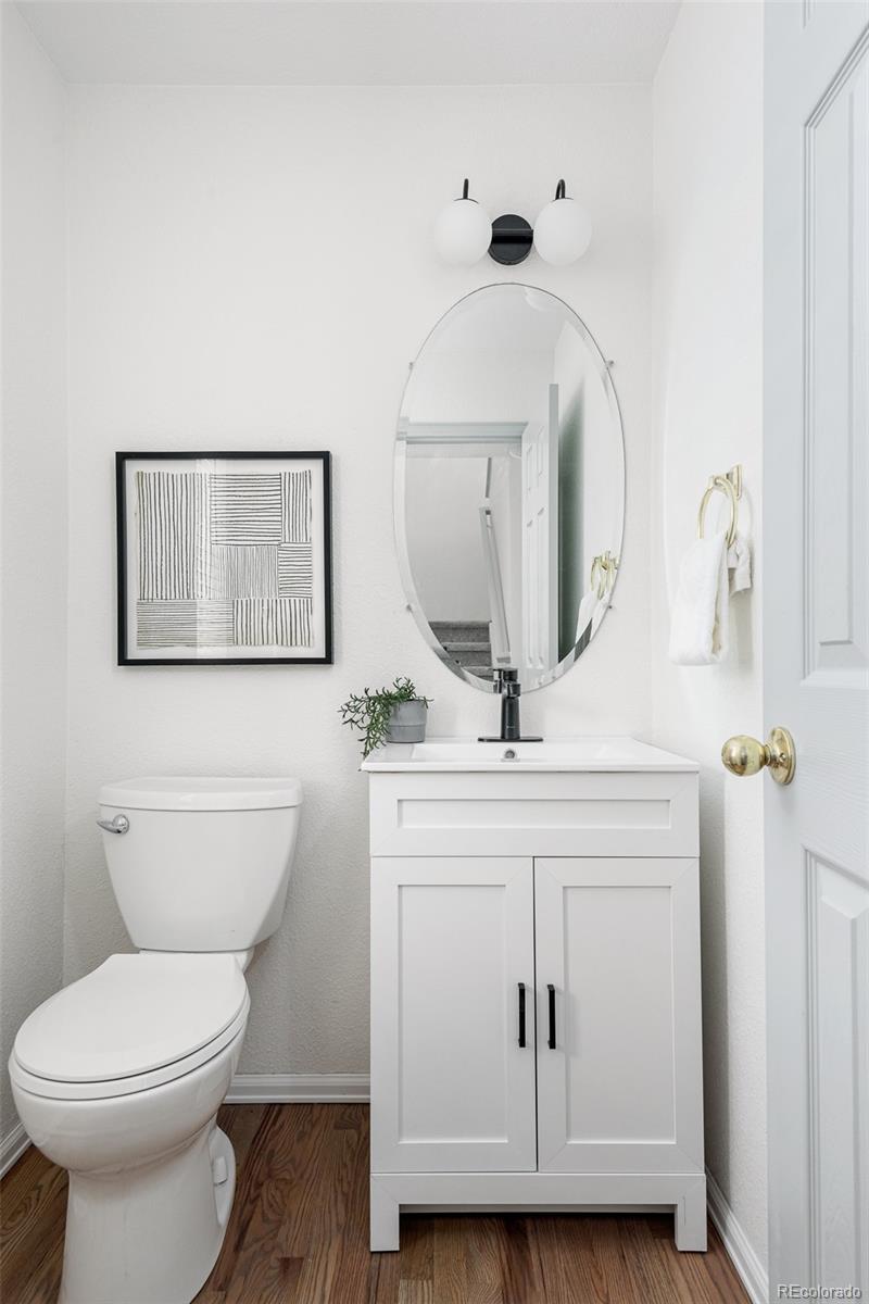 10754 West 107th Circle Westminster, CO 80021 - Photo 4 of 24 a bathroom with a toilet sink and mirror