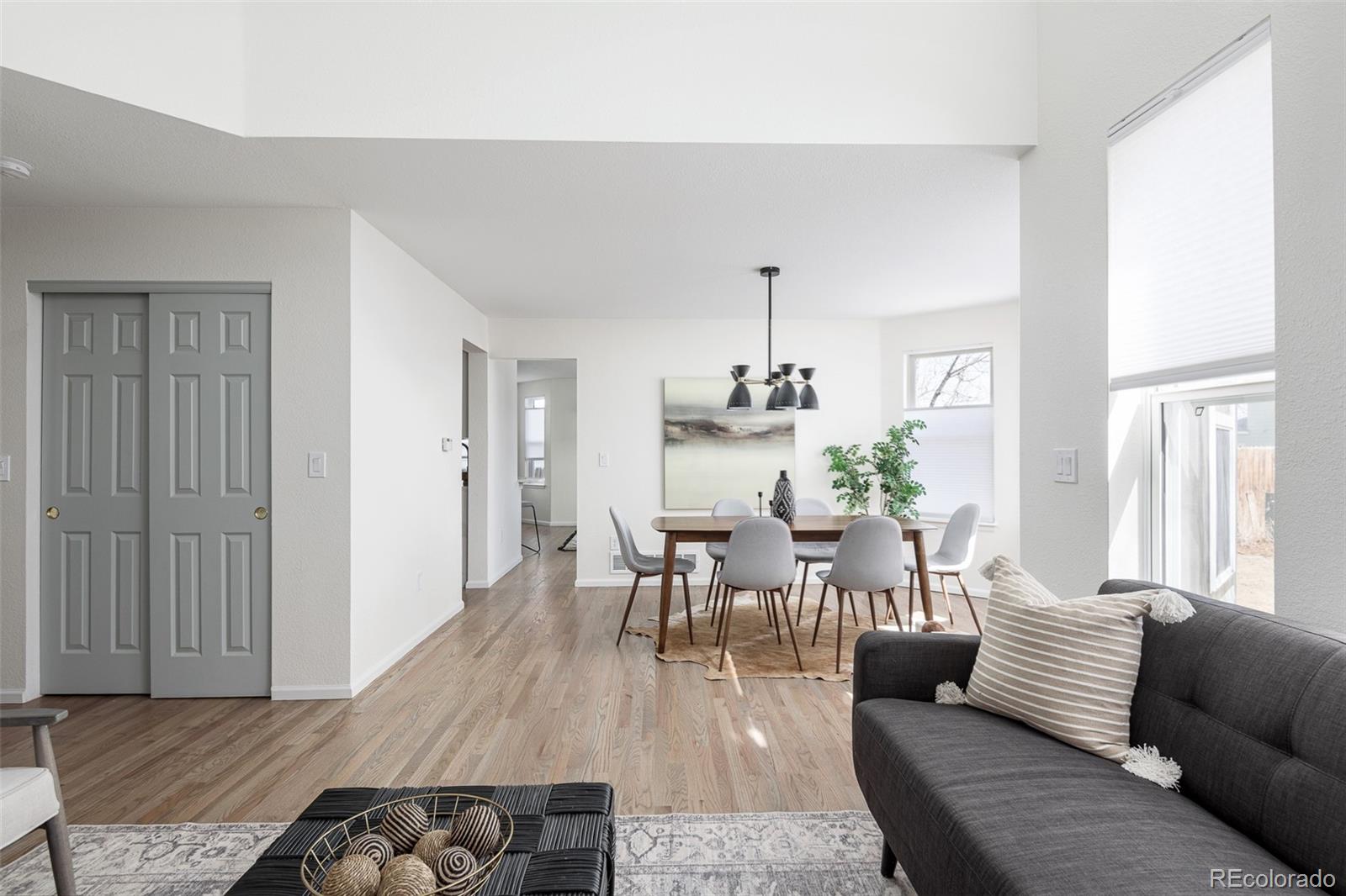 10754 West 107th Circle Westminster, CO 80021 - Photo 6 of 24 a living room with furniture and wooden floor