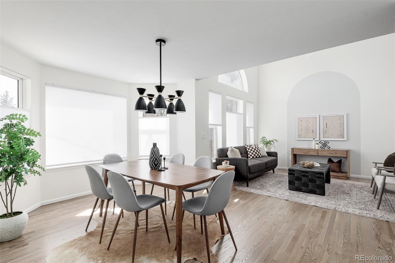 10754 West 107th Circle Westminster, CO 80021 - Photo 7 of 24 a view of a dining room with furniture window and wooden floor