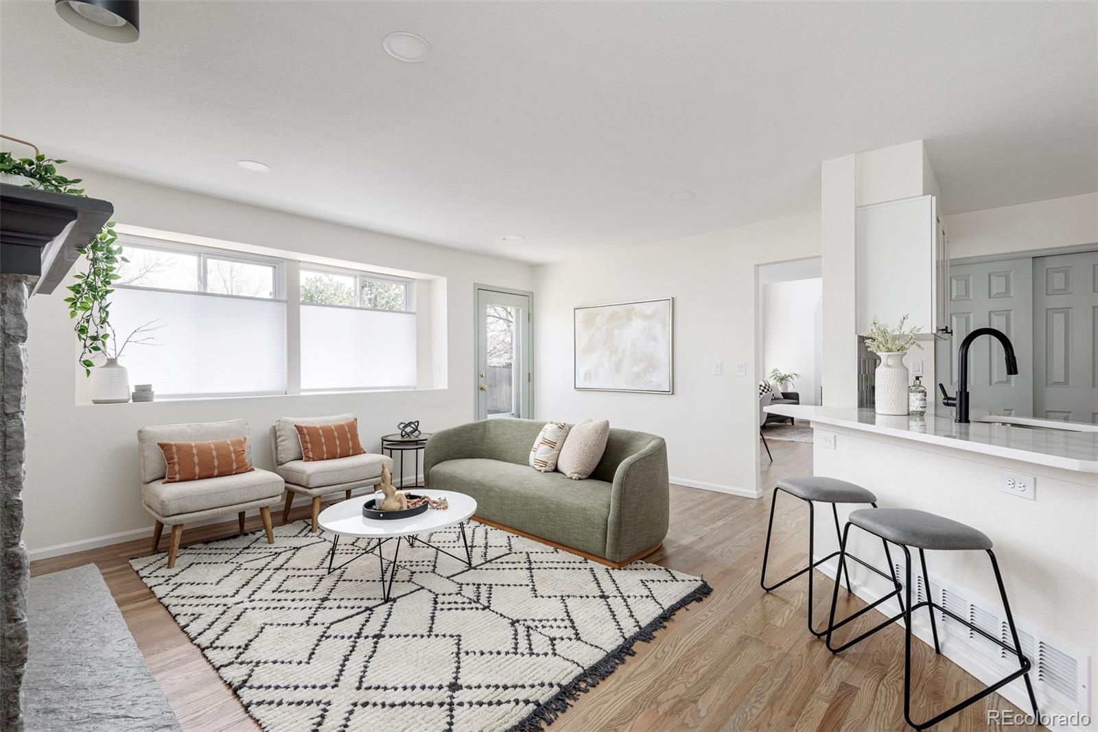 10754 West 107th Circle Westminster, CO 80021 - Photo 8 of 24 a living room with furniture and a window