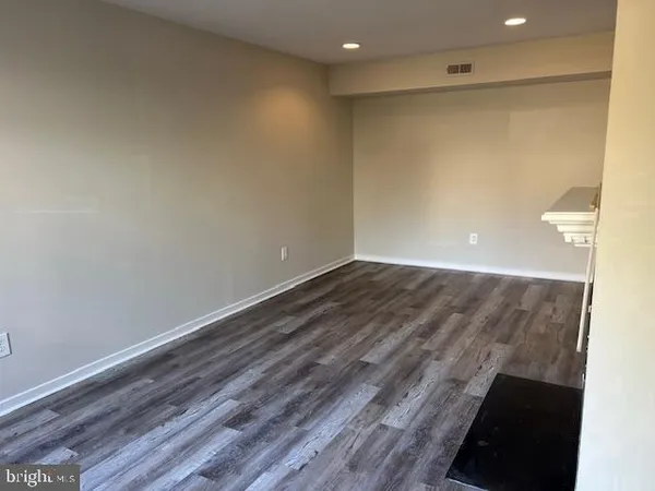 a view of room with wooden floor