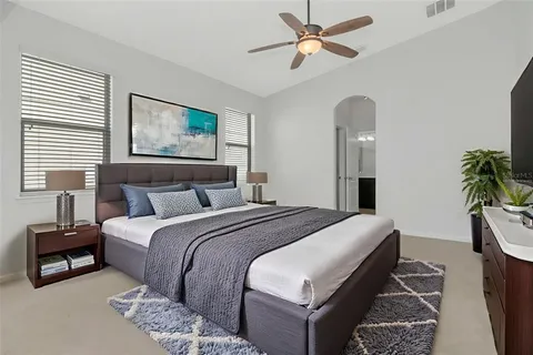 a bedroom with a bed and a chandelier