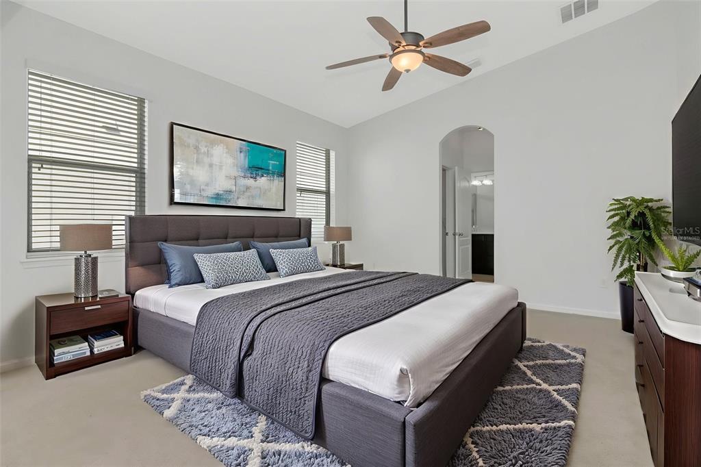 11229 Spring Point Circle Riverview, FL 33579 - Photo 12 of 40 a bedroom with a bed and a chandelier