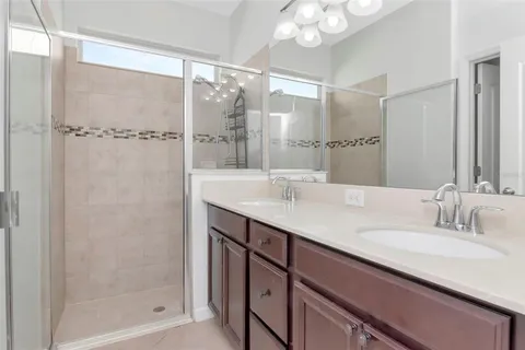 a bathroom with a shower sink and mirror
