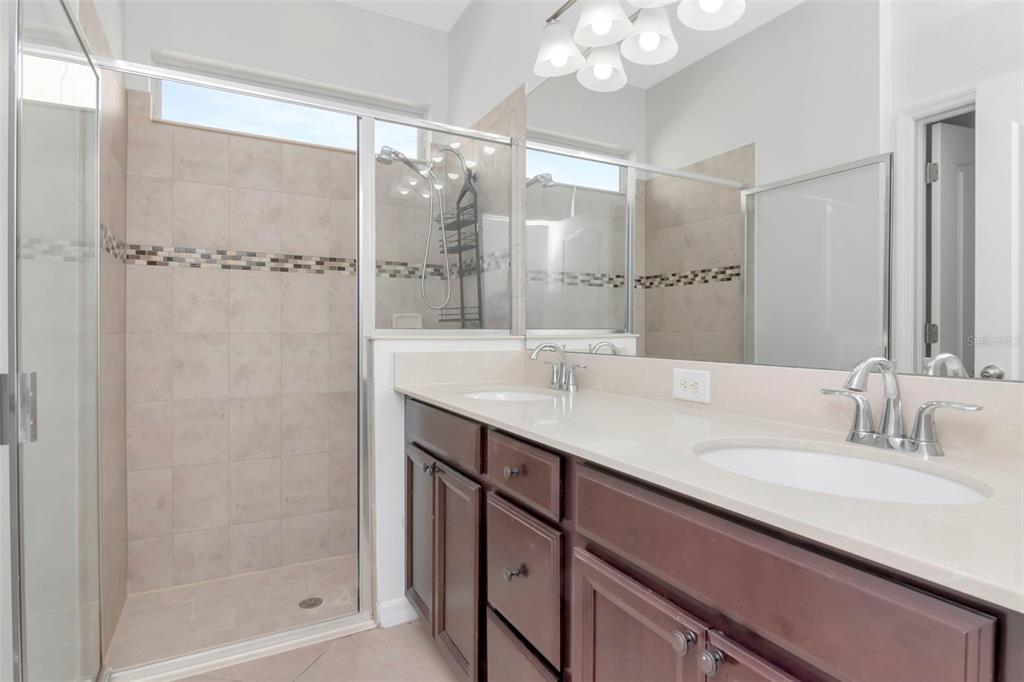 11229 Spring Point Circle Riverview, FL 33579 - Photo 15 of 40 a bathroom with a shower sink and mirror