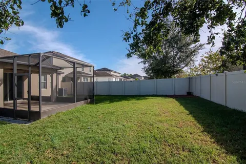 a view of a backyard with ceiling fan