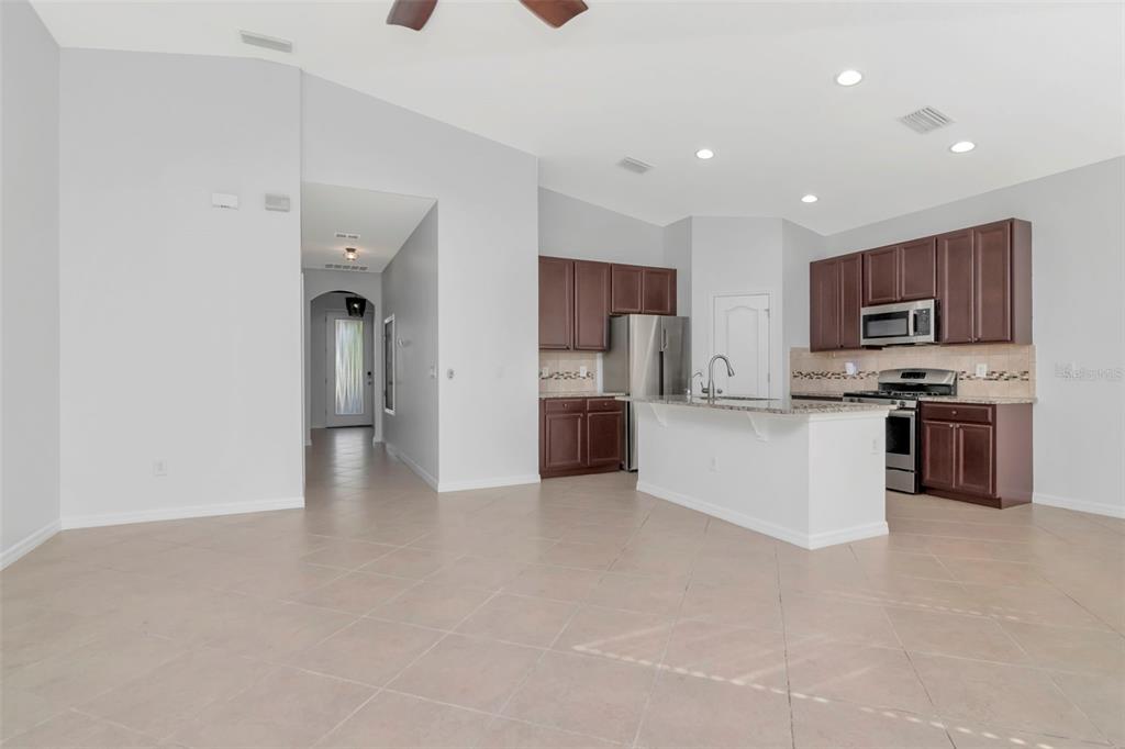 11229 Spring Point Circle Riverview, FL 33579 - Photo 4 of 40 a kitchen with stainless steel appliances a refrigerator and a stove top oven