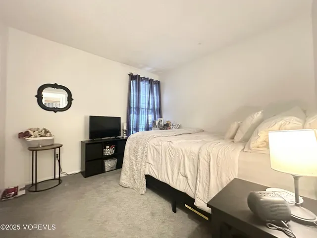 a bedroom with a bed and a chair