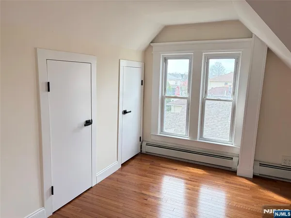 a view of a room with wooden floor and window