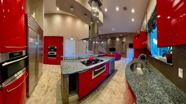 a kitchen with stainless steel appliances granite countertop a sink stove and cabinets
