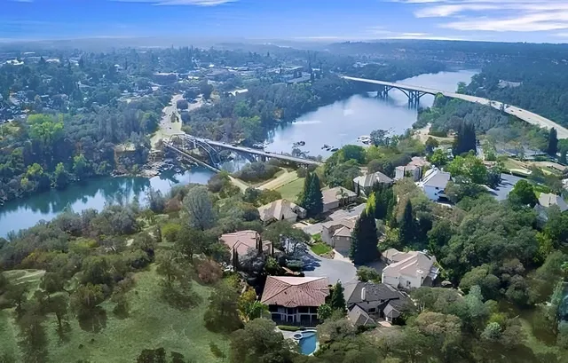 an aerial view of a house with garden space and a patio