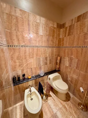 a view of a balcony with wooden floor and brick walls