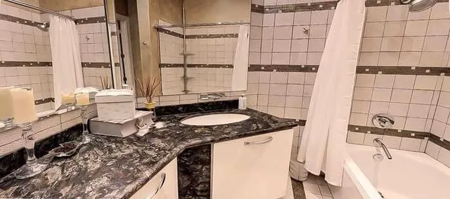 a bathroom with a double vanity sink and a mirror