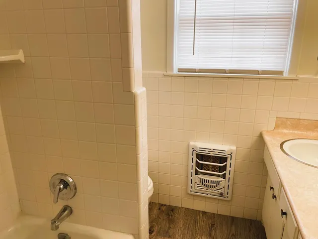 a bathroom with a sink a toilet and a window