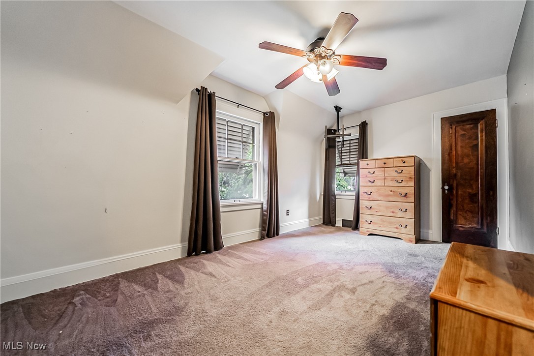11703 Granger Road Cleveland, OH 44125 - Photo 37 of 41 Carpeted bedroom with a ceiling fan and baseboards