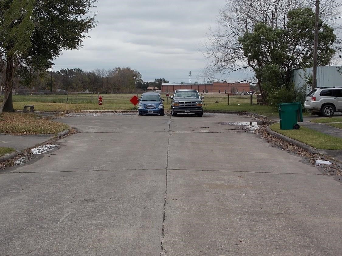 2619 Red Bluff Road Pasadena, TX 77506 - Photo 3 of 9 a view of road with card parked and large trees