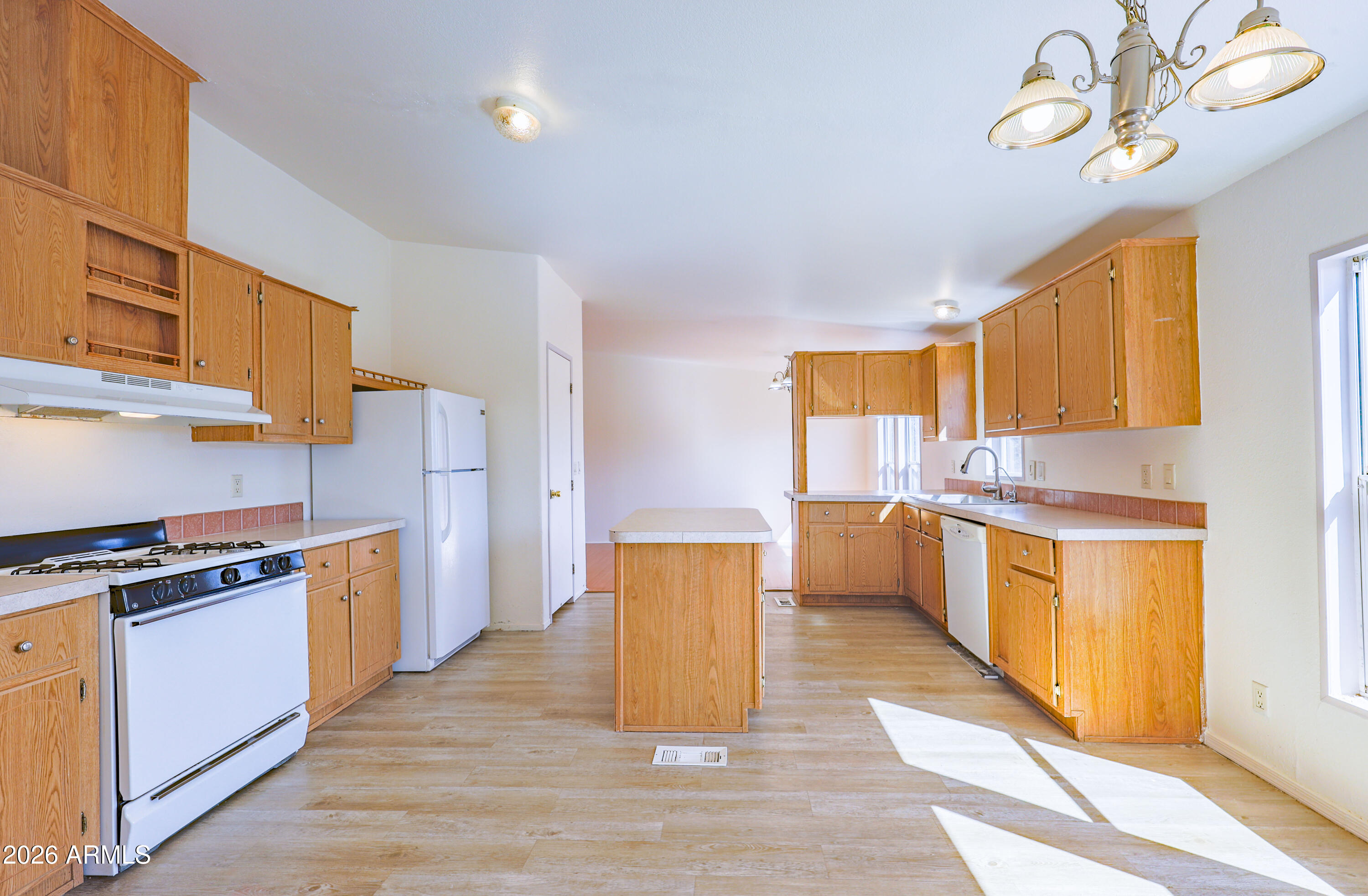 5144 Clearview Road Sierra Vista, AZ 85650 - Photo 11 of 32 a kitchen with a stove a sink and a refrigerator