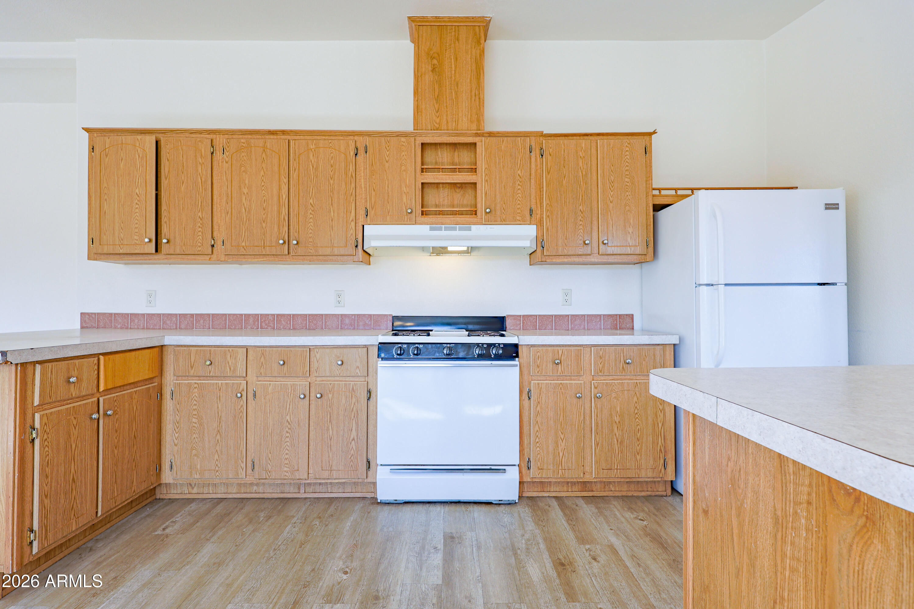 5144 Clearview Road Sierra Vista, AZ 85650 - Photo 12 of 32 a kitchen with stainless steel appliances granite countertop a refrigerator a stove a sink and white cabinets with wooden floor