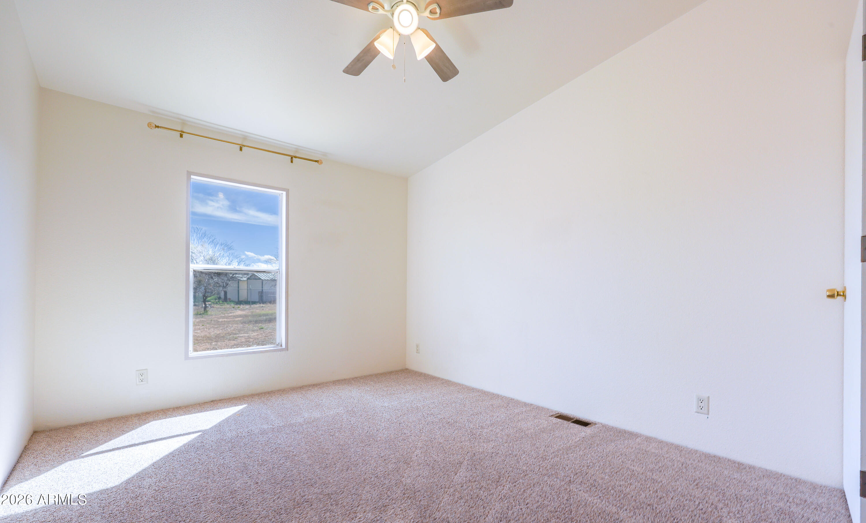 5144 Clearview Road Sierra Vista, AZ 85650 - Photo 27 of 32 an empty room with a chandelier fan and windows