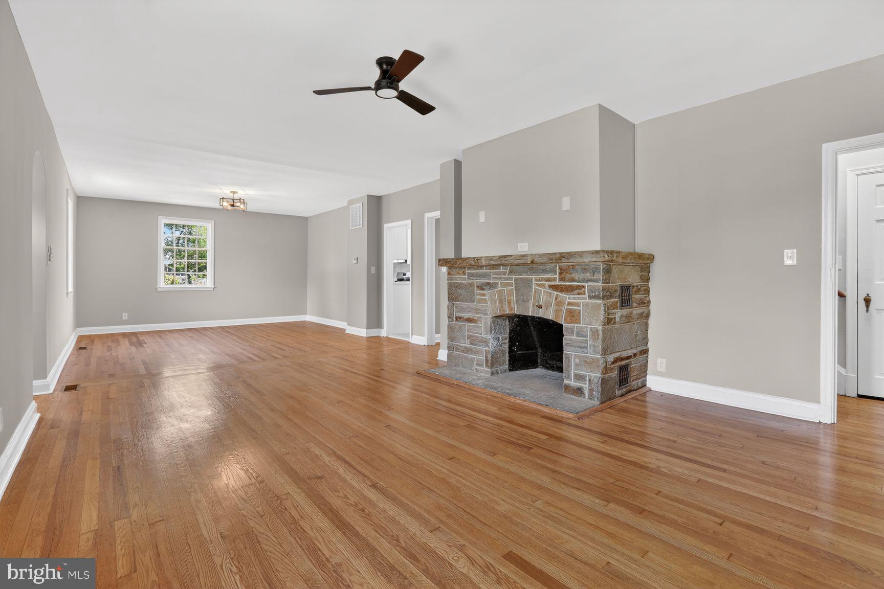 315 East Cold Spring Lane Baltimore, MD 21212 - Photo 3 of 25 a view of empty room with wooden floor and fireplace