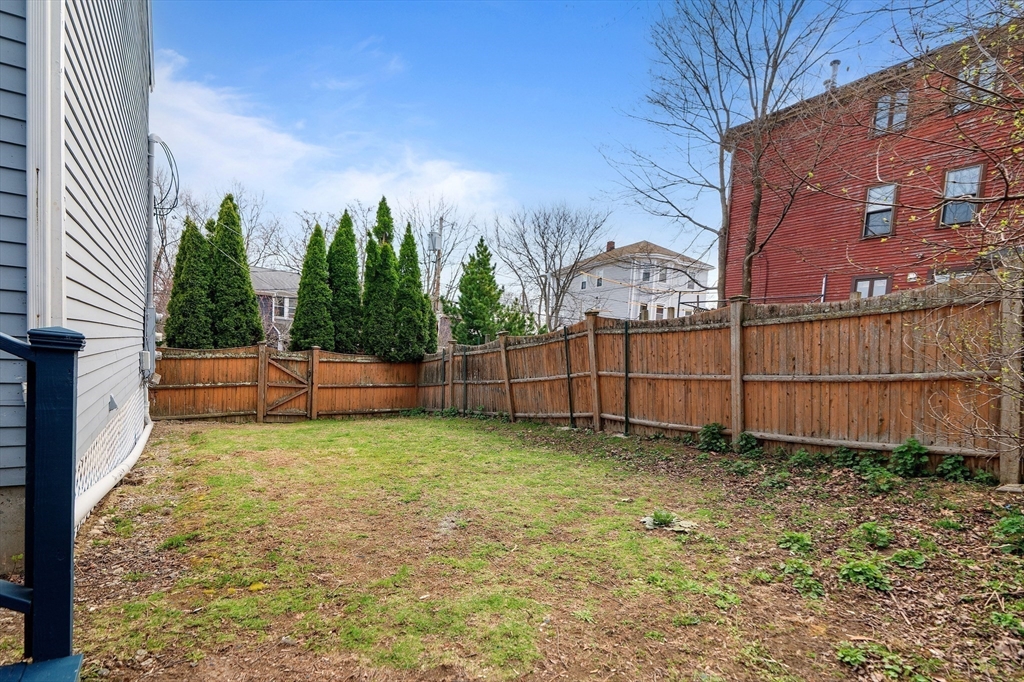 45 Lawn Street Boston, MA 02120 - Photo 18 of 22 a view of a backyard with a fence