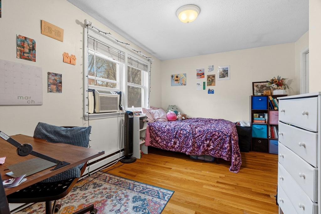 45 Lawn Street Boston, MA 02120 - Photo 10 of 22 a bedroom with a bed and wooden floor