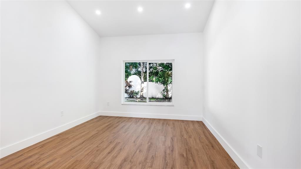 1811 Southwest 124th Way Miramar, FL 33027 - Photo 22 of 29 an empty room with wooden floor and window