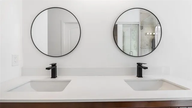 a bathroom with a sink a bathtub and a mirror